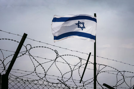 The concept of sanctions pressure on the israel government. Jewish flag in barbed wire, Sanctions pressure and aggression of Israel. The wall on the border of Israel and Syriaの写真素材