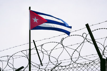 The concept of sanctions pressure on the Cuba government. Cuban flag in barbed wire, sanctions and aggression of Cuba. Cuban prison US sanctions against Cuba. The Cuban embargo.の写真素材
