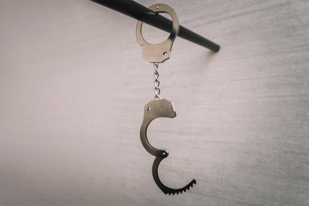 Classic chain handcuffs hanging on white background. concept of arrest of unfreedom.の写真素材