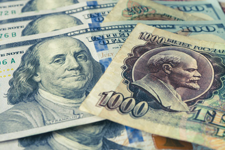 The Russian Soviet ruble and 100 of American dollars. confrontation between the capitalist and socialist systems. Cold War. Portraits of Vladimir Lenin and Benjamin Franklin on the national currency.の写真素材