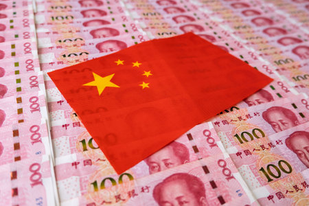 Money, currency of PBOC or people's bank of china. One hundred CNY Chinese yuan bill with a flag of China. 100 rmb or renminbi, depicts Beijing economy system, public banking policy and interest rateの写真素材