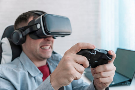 man gamer fun playing on futuristic simulation video shooting explore game in 3d glasses and joysticks in entertainment vr room with innovation technology. vr game and virtual reality.の写真素材