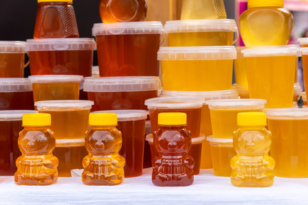 Many jars with fresh organic honey on farm market. Colorful honey in the jar on market in Altai.の写真素材