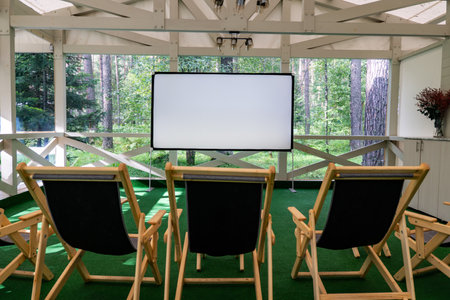 Outdoor movie screen in the park. Drive in movie theater. an empty white screen for outdoor viewing.