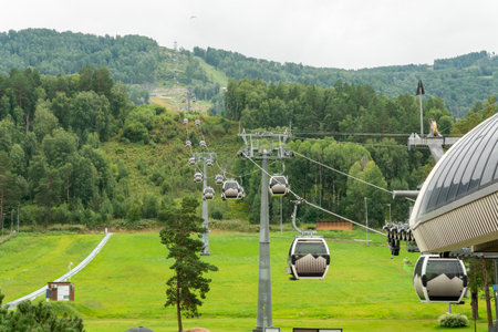 Manzherok resort, Russia. chairlift cab on the background of mountains and forests. Cable car trip to viewpoints in the mountains.の写真素材