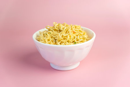 Boiled instant noodles on a pink background. Fast food. Modern food. Asianfood, bright pink background color.の写真素材