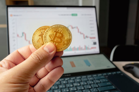 Hand holding golden coin crypto currency stock trade graph background new investment market. concept...