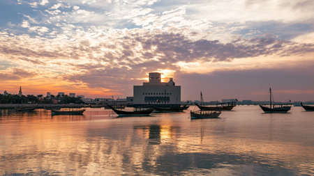 An Evening view of corniche in Doha, Qatar in the evening at sunset. Traditional Arabic Dhow boats in Doha harbour, Qatarの写真素材