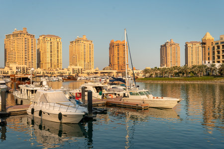 The marina waterfront walkway at the Pearl in Doha, Qatar, with shops and restaurantsの写真素材