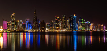 Doha skyline view with amazing sea. night scene, beautiful panoramic view of Doha from the sea at night.の写真素材