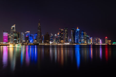 Futuristic urban skyline of modern skyscrapers at night in Doha, Qatarの写真素材