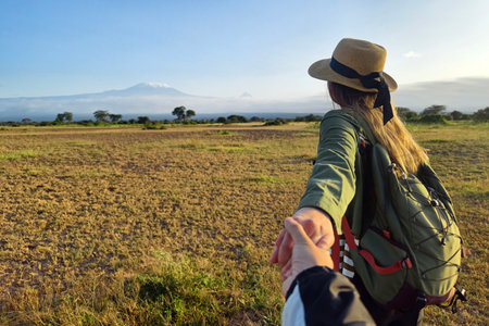 Follow me concept and traveling together. Girl traveler wearing hat round straw, bag and short...