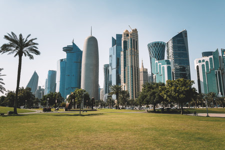 The high-rise district of Doha, seen from the Hotel Park, with green lawn and artificial hill in the...