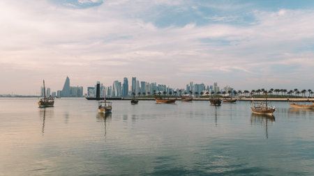 An Evening view of corniche in Doha, Qatar in the evening at sunset. Traditional Arabic Dhow boats in Doha harbour, Qatarの写真素材