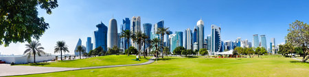 Tall modern skyscrapers tower over the central park in Doha Qatar.