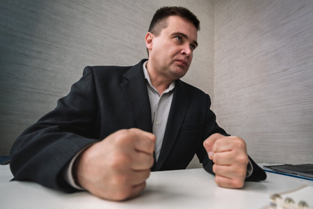 Dealing with anger at work. strict boss feel anger at work. Businessman show fist in anger. Anger managements. Managing stress. Business problem and conflict. Tame your temper. Stay in controlの写真素材