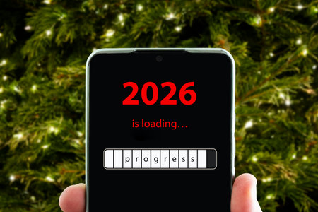 the concept of changing the year from 2025 to 2026. smartphone on the computer keyboard with the...