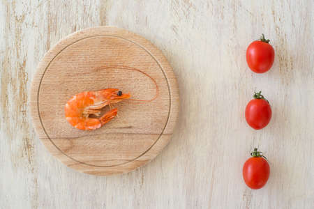 composition with a shrimp and tomatoes on a kitchen tableの写真素材