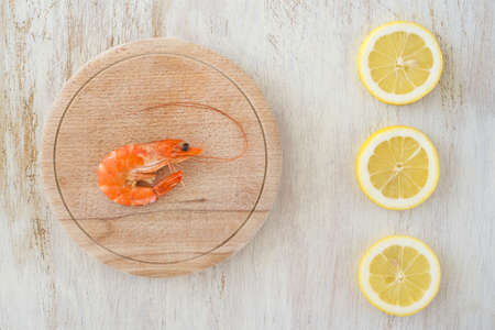 composition with a shrimp and lemons on a kitchen tableの写真素材