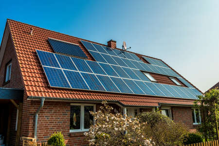 Solar panel on a red roofの写真素材