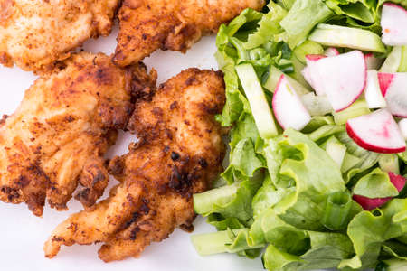 fried chicken with salad and potatoesの写真素材