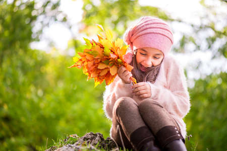 Adorable little girl outdoors at beautiful autumn dayの写真素材