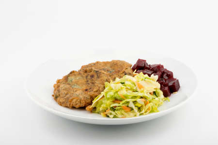 Vegetable meatballs garnished with beetroot and cabbage. Front view. Selective focus. White...