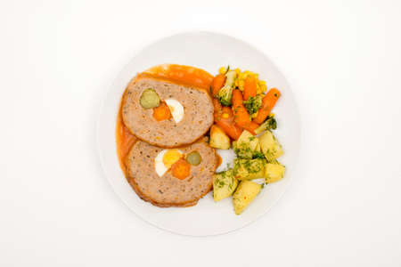Roll of meat and vegetables. Top view. Selective Focus White background.