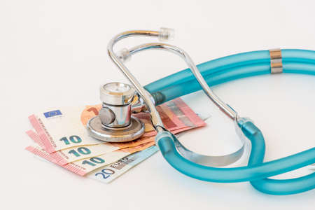 Expensive health treatment.  Stethoscope on money backgroundの写真素材