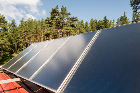 Solar panel on a red roofの写真素材
