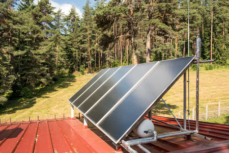 Solar panel on a red roofの写真素材