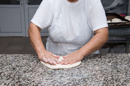 close up of female hands kneading dough and making banitsa - typical bulgarian pastryの写真素材
