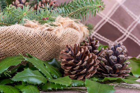 Christmas decoration with fir branches, mistletoe, wood cookies and gifts - still lifeの写真素材
