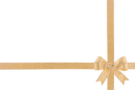 Golden ribbon with a bow on white backgroundの写真素材