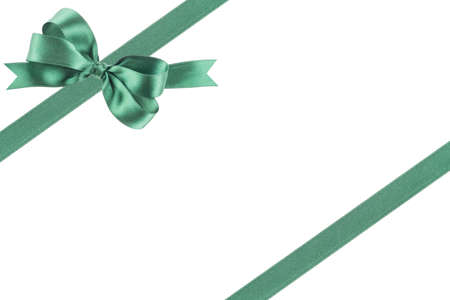 Green ribbon with a bow on white backgroundの写真素材