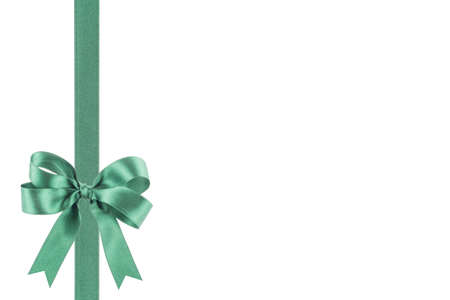 Green ribbon with a bow on white backgroundの写真素材