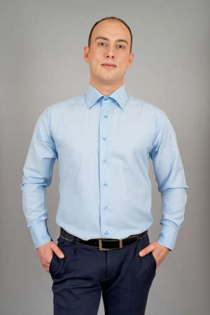 Handsome smiling businessman. Isolated over gray backgroundの写真素材