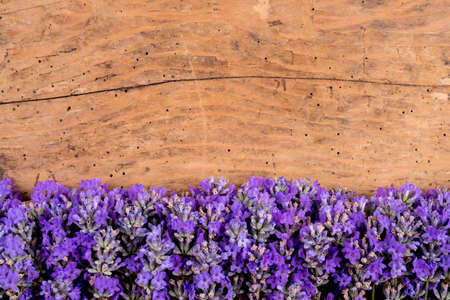 frame of lavender on a rustic wooden background - selective focus, copy spaceの写真素材