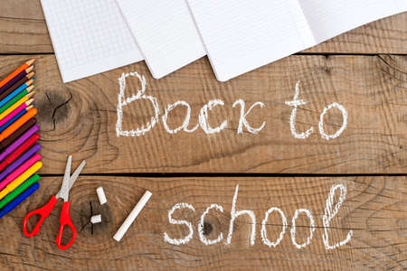 school supplies on vintage table with back to school inscription
