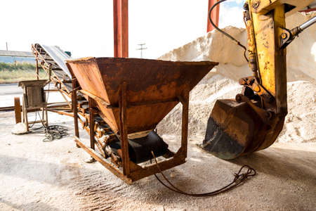 salt production - pile of salt and excavator at saltworks - selective focus, copy spaceの写真素材