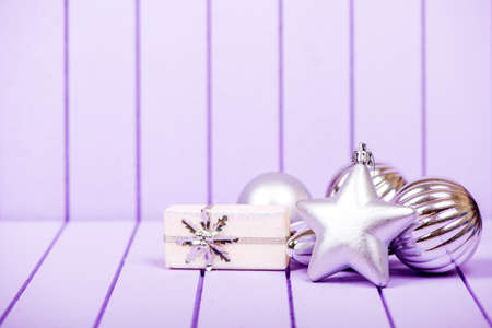 Christmas decoration with fir branches on a purple striped background - selective focus, copy spaceの写真素材
