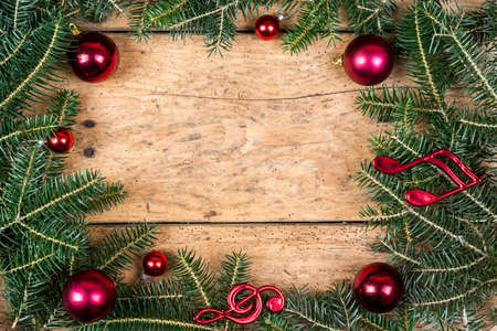 Christmas frame of fir branches over vintage wood - copy space