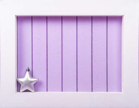 White wooden frame and  christmas decoration over a purple background - copy spaceの写真素材