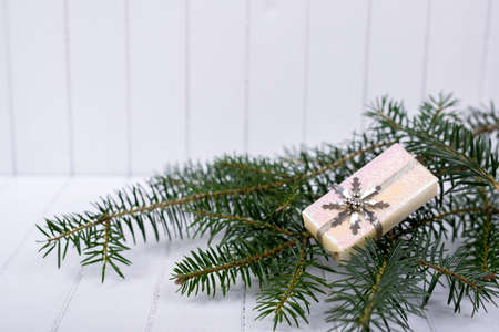 Christmas decoration with fir branches on a white striped background - selective focus, copy spaceの写真素材