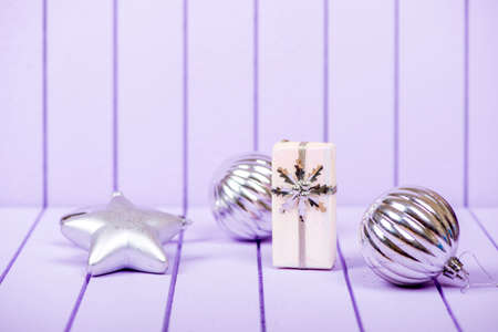 Christmas decoration with fir branches on a purple striped background - selective focus, copy spaceの写真素材