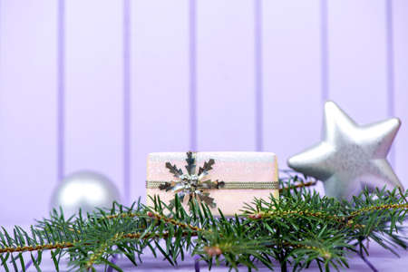 Christmas decoration with fir branches on a purple striped background - selective focus, copy spaceの写真素材