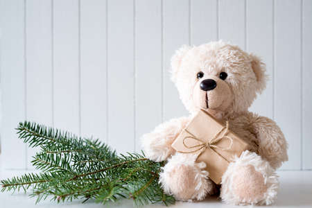 Christmas background with teddy bear and fir branchesの写真素材