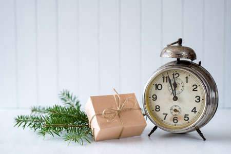 Christmas background with old alarm clock and a giftの写真素材