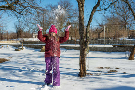 little girl playing with snow - selective focus