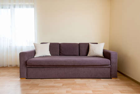 living room with a sofa, windows and curtains - copy spaceの写真素材